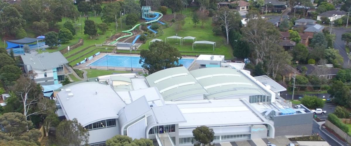 aerial view of the Aquarena facilities including the main building and the outdoor pools and green space