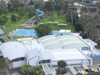 aerial view of the Aquarena facilities including the main building and the outdoor pools and green space